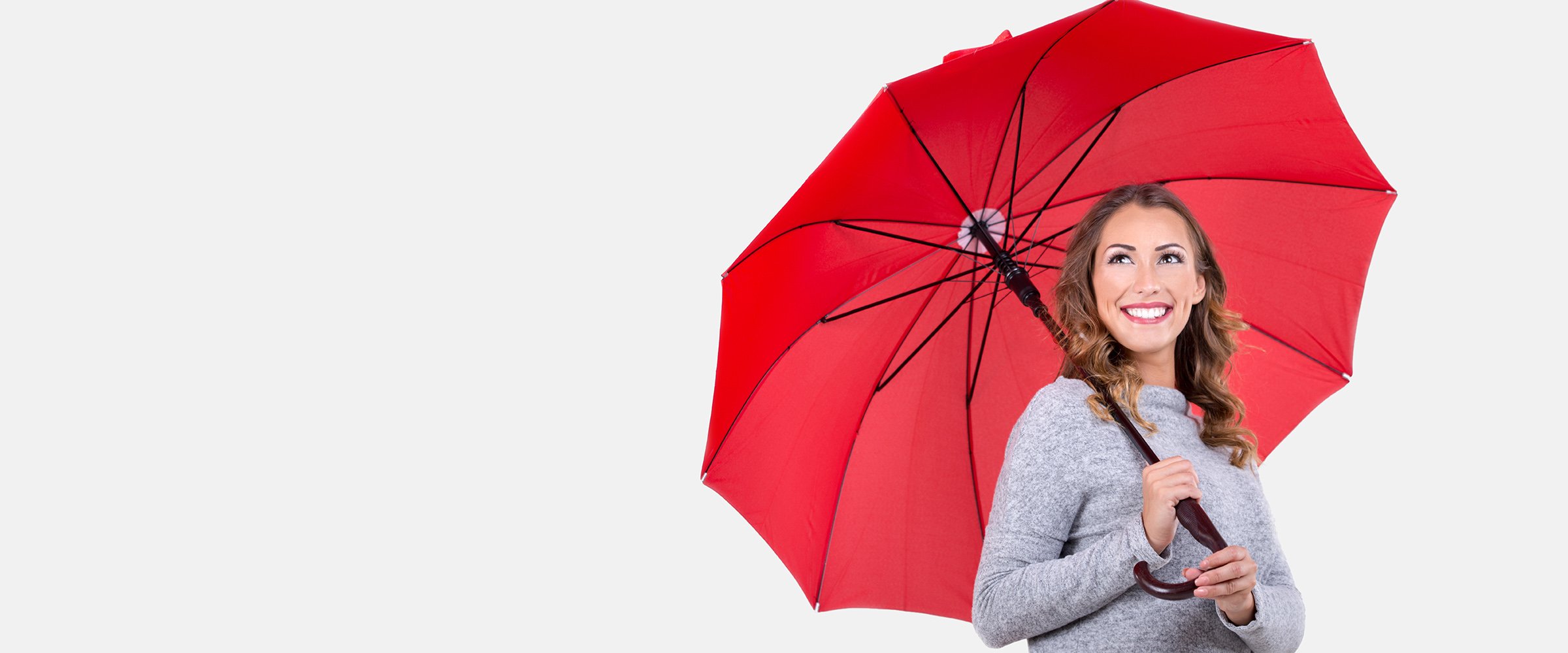 A picture of a woman holding an umbrella and smiling representing protection by a MidTenn Alarms security system